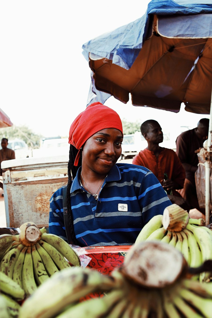 A trader smiling at her market stall